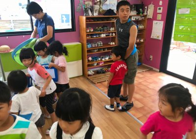 Hirotaka helping little kids